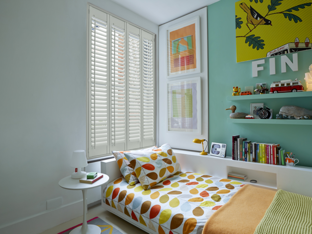 Cream shutters in a vivid bedroom for a child