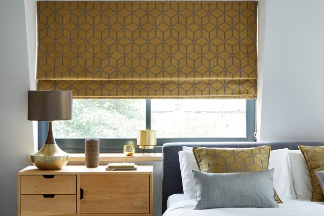bedroom with gold nexus brushed gold roman blinds