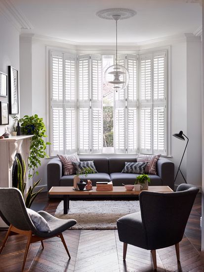 Windsor Silk White tier-on-tier shutters in a living room
