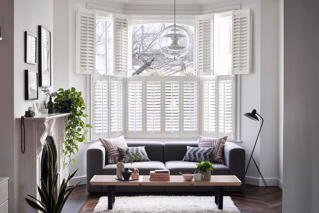Windsor Silk White tier-on-tier shutters in a living room