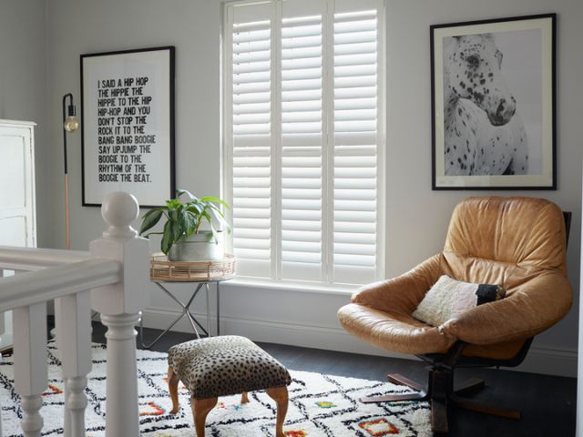 full height silk white shutters made of richmond material installed on windows of wall in  hallway