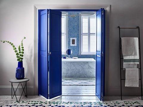 Bright blue solid shutters in bathroom