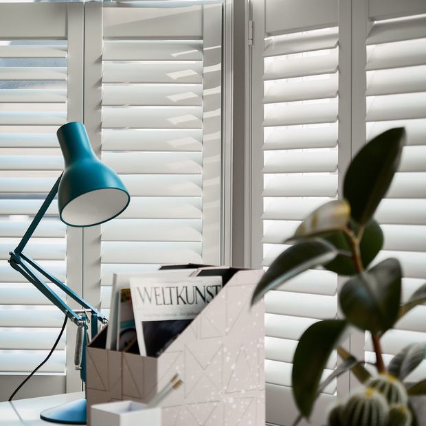 White tier on tier shutters in a home office