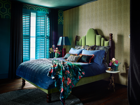 Green custom colour shutters in a bedroom