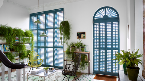 Bright blue shaped shutters in hall