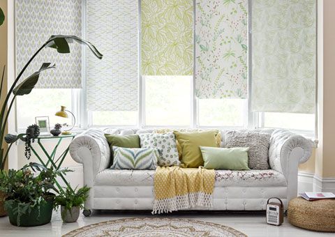A mix of printed Roller blinds in a bay window