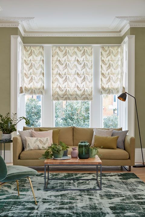 Tonal green living room with leaf motif Roman blinds