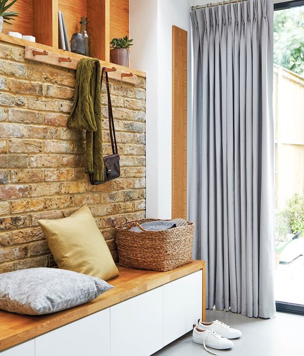 Boot room with exposed brickwork and dove grey curtains