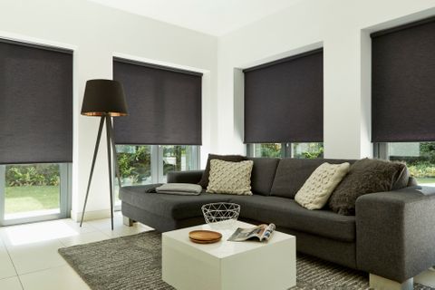 Plain dark Norfolk Charcoal roller blind hung in living room