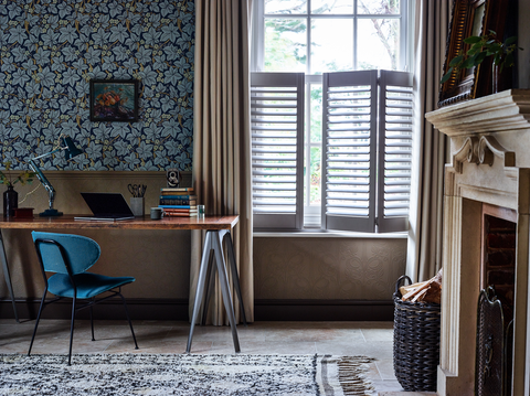 Home office with curtains layered over cafe style shutters