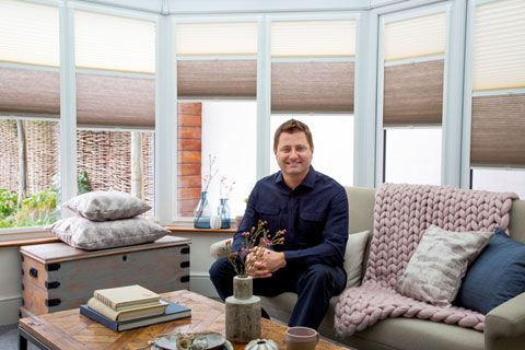 Close up of Architect and TV presenter George Clarke sitting in conservatory