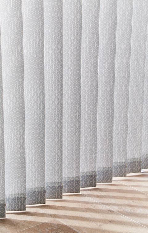 Close up of floor length grey pattern vertical blinds