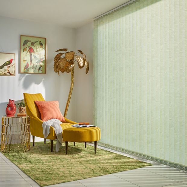 Modern tropical lounge with full length green vertical blinds