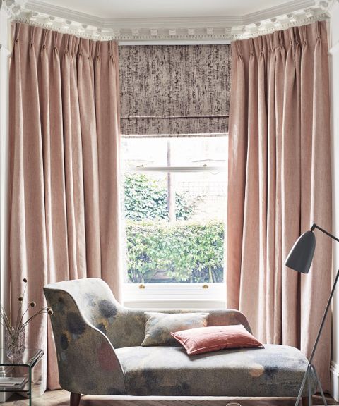 Luxe Pink living room with Pink Curtains in Mineral Blush fabric layered with a Grey Pattern Roman Blind 