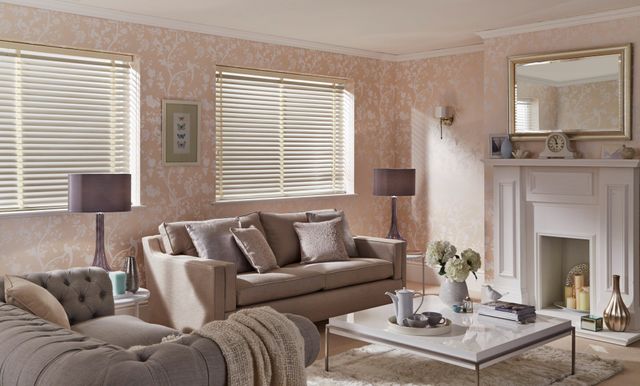 Traditional living room in soft pink hues with cream venetian blinds