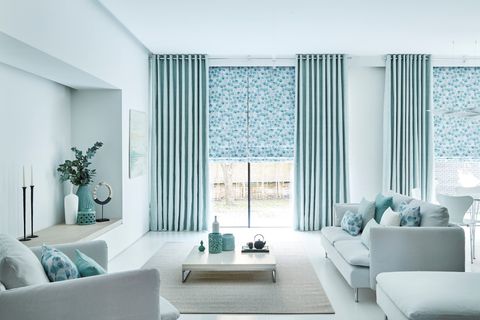Blue Curtains in Origami Mist Fabric paired with Blue Patterned Roman Blinds in Honesty Mist Fabric in a contemporary Living Room
