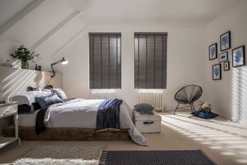 dark grey venetian blinds in a bedroom window 