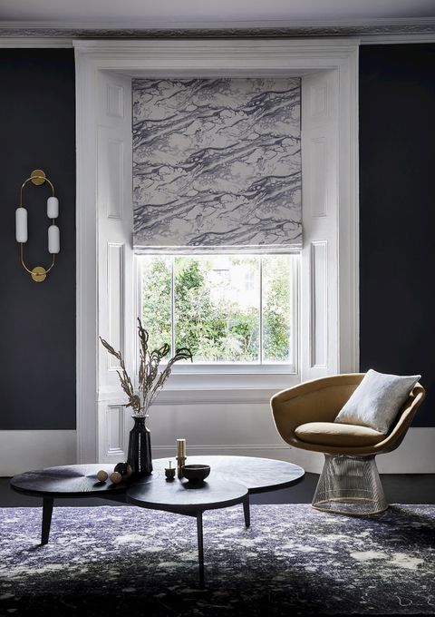 Living room with grey marbled Roman blind at single window