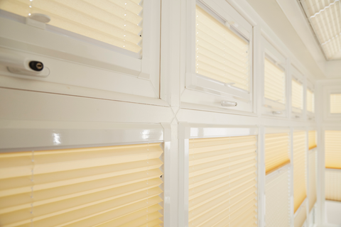 Close up of yellow thermal blinds in conservatory 
