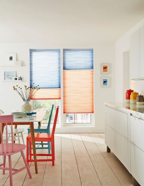 Colourful kitchen with full length windows with orange and blue thermal blinds