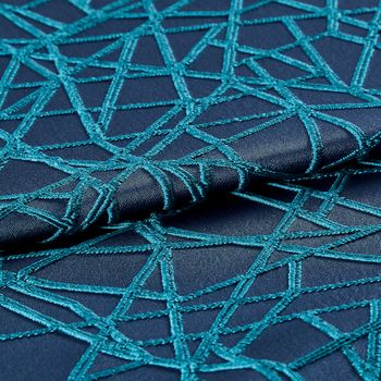 The blue and cyan Zodiac Deep Cyan fabric, folded in two sections, from the Mercury collection
