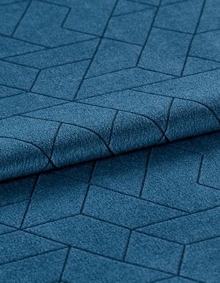 Folded dark blue material with a repeating geometric pattern