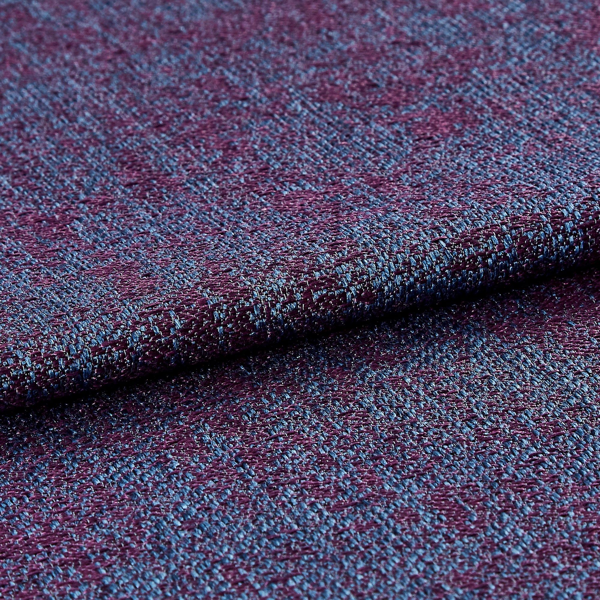 Purple and blue coloured fabric that repeats across the material 