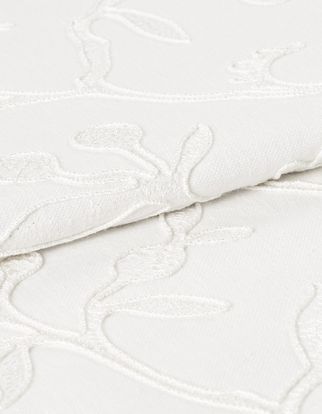 White coloured fabric of Adhara Whisper with detailed stem design woven into the material 