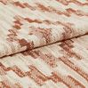 Cream coloured base fabric which is patterned in a repeating tribal design in dark orange 