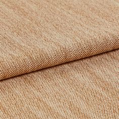 Fabric decorated in a bright sand colour while the material has been folded over