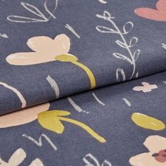 Dark blue fabric decorated with a repeating pattern of flowers in various styles