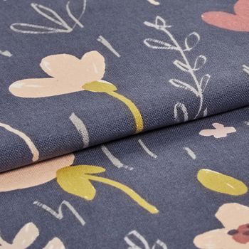 Dark blue fabric decorated with a repeating pattern of flowers in various styles