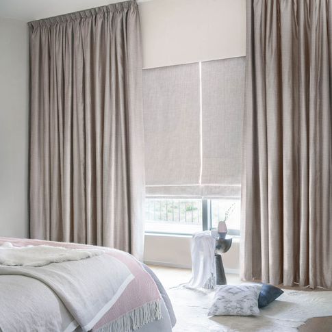 Arlington shingle curtains and allure bamboo Roman blinds in a bedroom