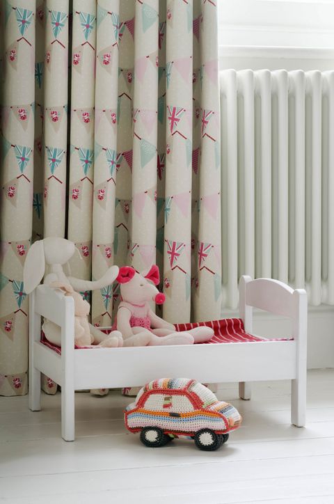 Close up of bunting chintz curtains in children bedroom
