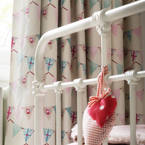 Close up of bunting chintz curtains in children bedroom