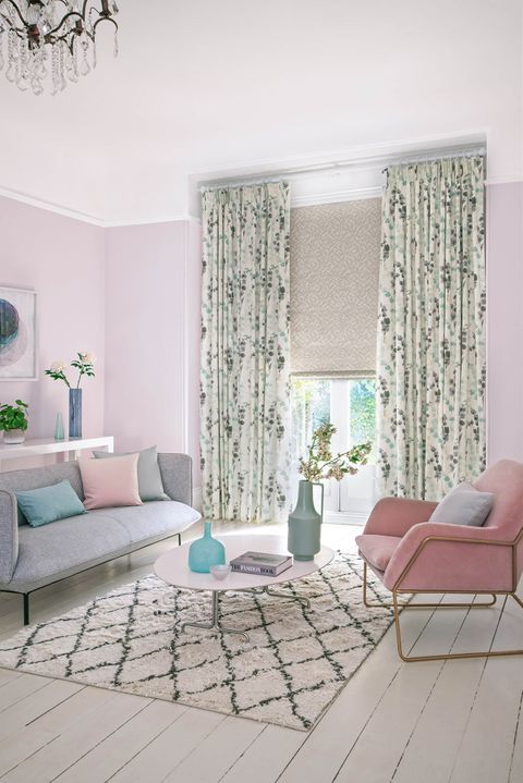 Light and fresh living room with lilac floral curtains and a lavender geometric print Roman blind