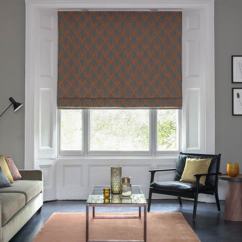 Dimension Ember geometrical patterned Roman blinds in grey and copper in a grey living room