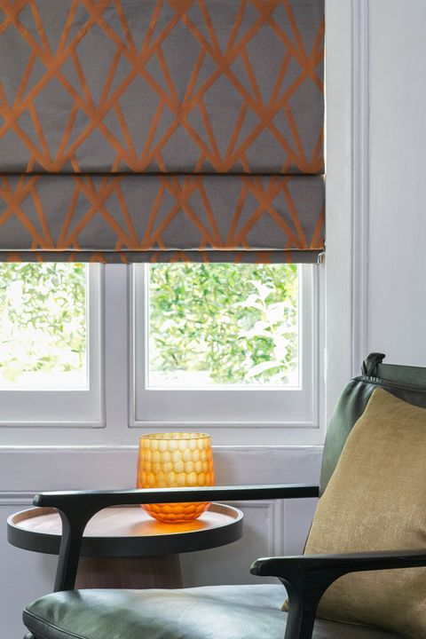 Close up of Dimension Ember roman blinds in living room