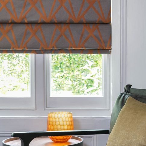 Close up of Dimension Ember roman blinds in living room