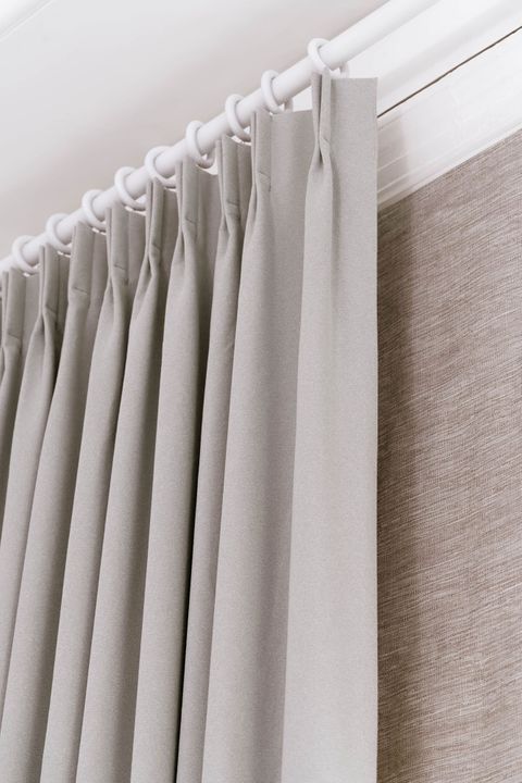 Close up of double pinch pleat header type on white curtain pole