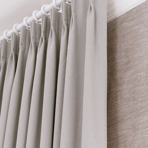 Close up of double pinch pleat header type on white curtain pole