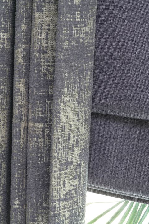 Close up of  Infinity Lilac Grey curtains and Clarence Mauve romans in the living room
