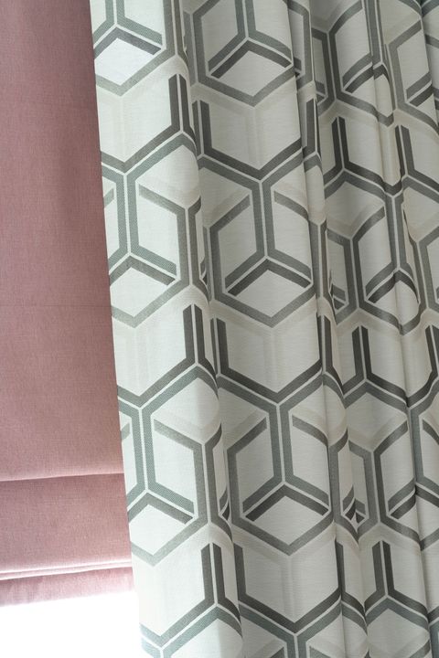 Close up of Metro Pewter curtains and Bailey Taffy romans in living room