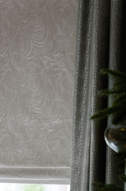 Close up of Muse Pearl curtains and Daze Silver roman blinds in dining room