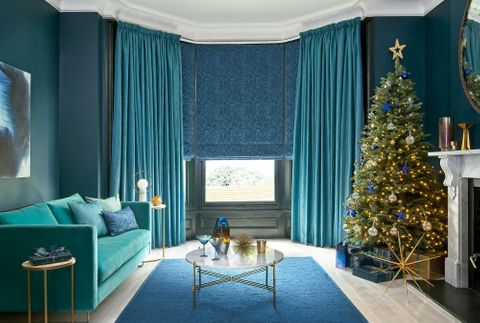 Surface Peacock curtains and Muse Deep Lapis romans in the living room decorated for chritsmas