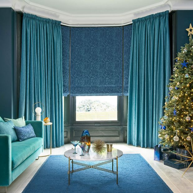 Surface Peacock curtains and Muse Deep Lapis romans in the living room decorated for chritsmas