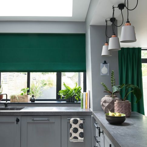 Green curtains and roman blinds in kitchen 