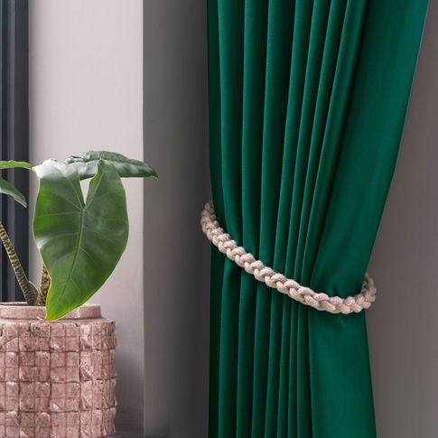 Green curtains with accessories in kitchen