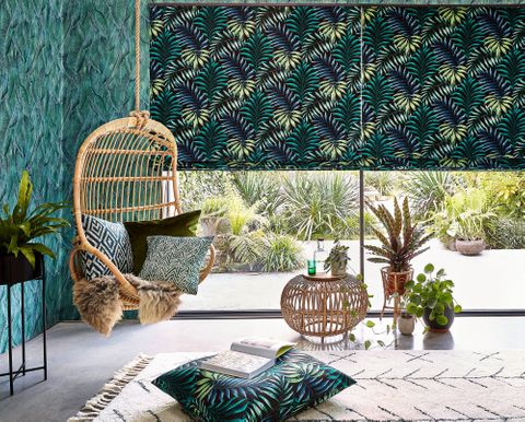 Green and yellow  printed roman blinds, patterned and printed cushions on leisure hanging chair 