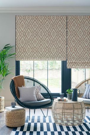 Cream and brown diamond patterned Roman blinds in a blue garden room with plants